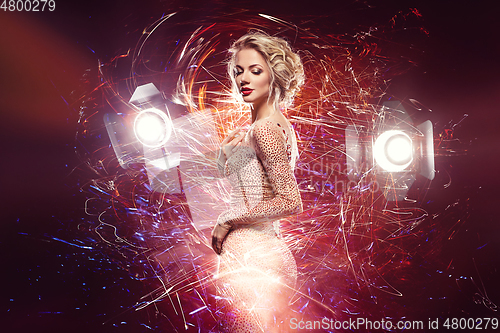 Image of beautiful girl in evening dress surrounded by light