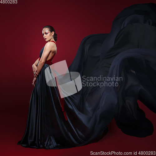 Image of beautiful woman in flying silk dress