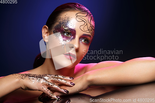 Image of beautiful woman with bright makeup with glitter