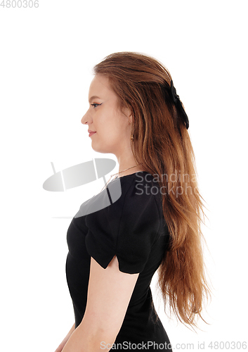 Image of Portrait of brunette woman in a black dress