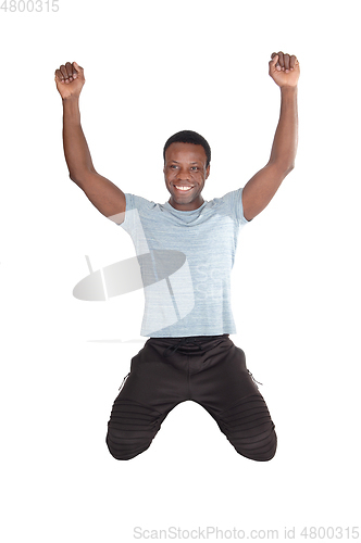 Image of Happy African man with kneeling looking up