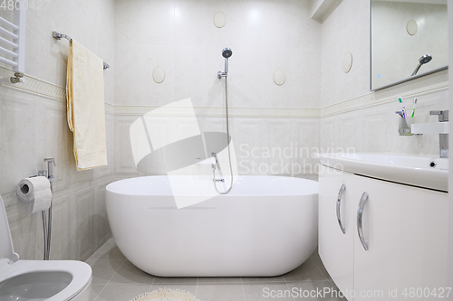 Image of Compact white cozy bathroom with bathub