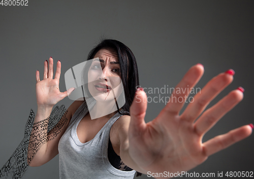 Image of Woman in fear of domestic abuse and violence, concept of female rights