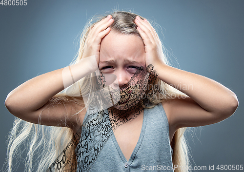 Image of Sad and frightened little girl with bloodshot and bruised eyes, fiction of happiness