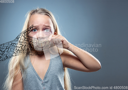 Image of Sad and frightened little girl with bloodshot and bruised eyes, fiction of happiness