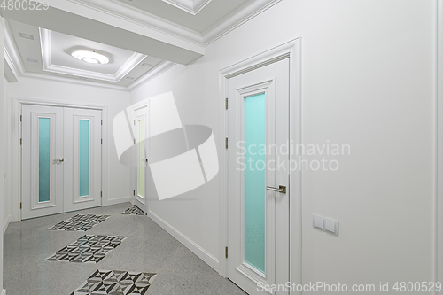 Image of interior of white corridor with doors