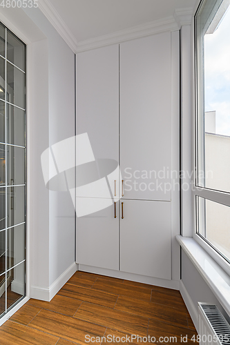 Image of Empty heated penthouse living room with floor to ceiling windows