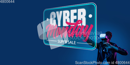 Image of Half-length close up portrait of young woman in neon light with cyber monday lettering