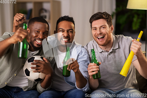 Image of friends or soccer fans with ball and beer at home