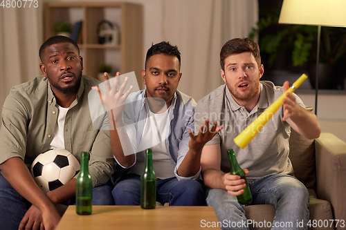Image of sad male friends or soccer fans with beer at home