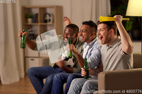 Image of friends or soccer fans with ball and beer at home