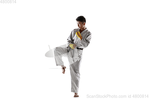 Image of Confident korean man in kimono practicing hand-to-hand combat, martial arts