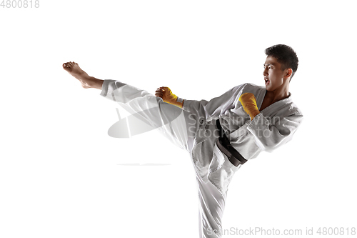 Image of Confident korean man in kimono practicing hand-to-hand combat, martial arts