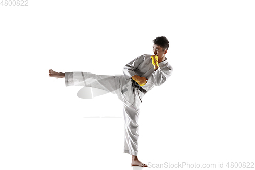 Image of Confident korean man in kimono practicing hand-to-hand combat, martial arts