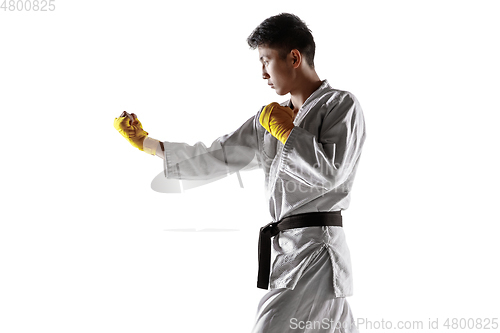 Image of Confident korean man in kimono practicing hand-to-hand combat, martial arts