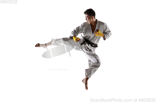 Image of Confident korean man in kimono practicing hand-to-hand combat, martial arts