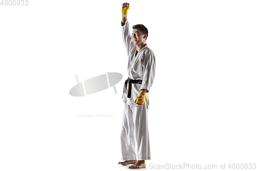 Image of Confident korean man in kimono practicing hand-to-hand combat, martial arts