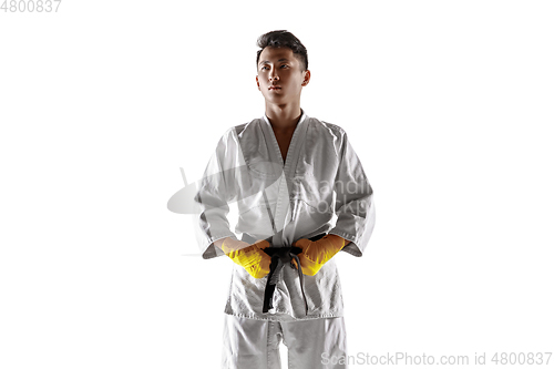 Image of Confident korean man in kimono practicing hand-to-hand combat, martial arts