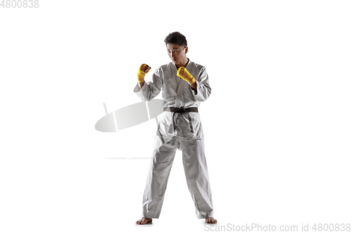 Image of Confident korean man in kimono practicing hand-to-hand combat, martial arts