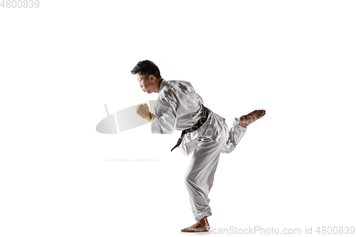 Image of Confident korean man in kimono practicing hand-to-hand combat, martial arts