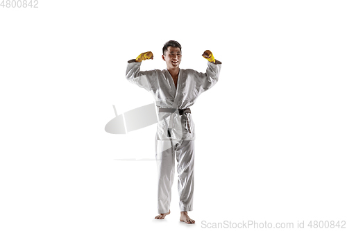 Image of Confident korean man in kimono practicing hand-to-hand combat, martial arts