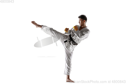 Image of Confident korean man in kimono practicing hand-to-hand combat, martial arts