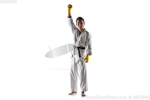 Image of Confident korean man in kimono practicing hand-to-hand combat, martial arts