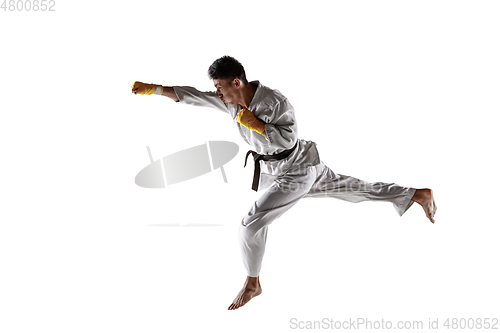 Image of Confident korean man in kimono practicing hand-to-hand combat, martial arts