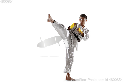 Image of Confident korean man in kimono practicing hand-to-hand combat, martial arts