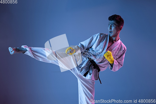 Image of Confident korean man in kimono practicing hand-to-hand combat, martial arts