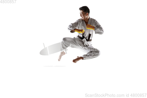Image of Confident korean man in kimono practicing hand-to-hand combat, martial arts
