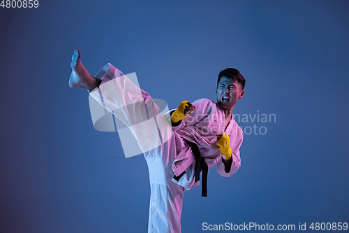 Image of Confident korean man in kimono practicing hand-to-hand combat, martial arts