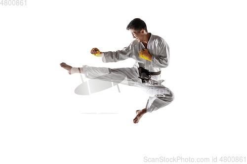 Image of Confident korean man in kimono practicing hand-to-hand combat, martial arts