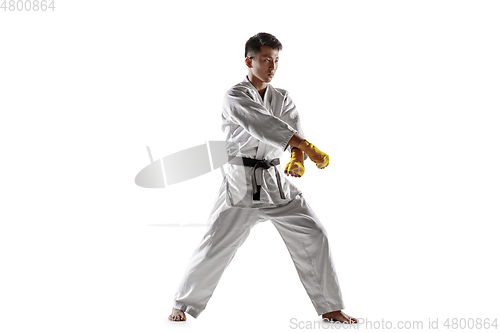 Image of Confident korean man in kimono practicing hand-to-hand combat, martial arts