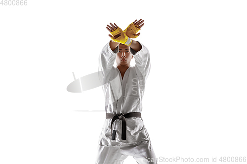 Image of Confident korean man in kimono practicing hand-to-hand combat, martial arts