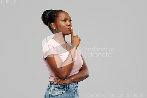 Image of african american woman with finger on lips