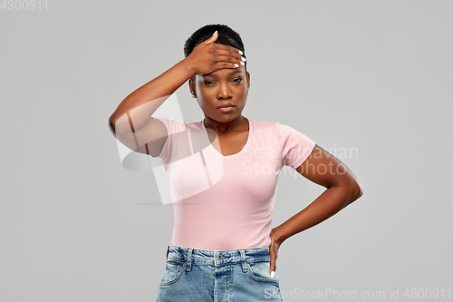 Image of african american woman having headache or fever