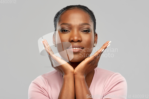 Image of happy african american woman over grey background