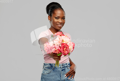 Image of happy african american woman with bunch of flowers