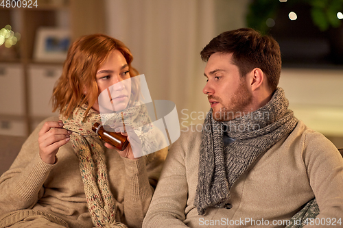 Image of sick couple with medicine or antipyretic syrup