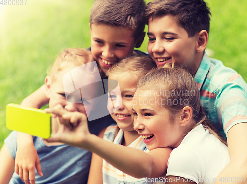 Image of happy kids or friends taking selfie in summer park