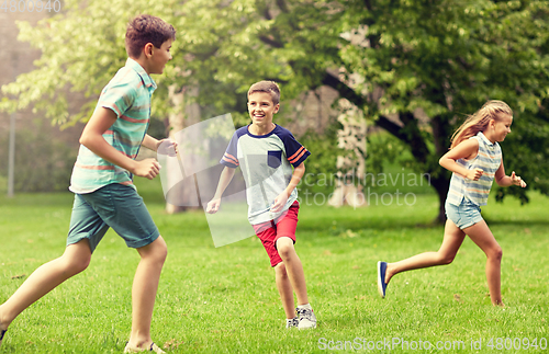 Image of happy kids running and playing game outdoors