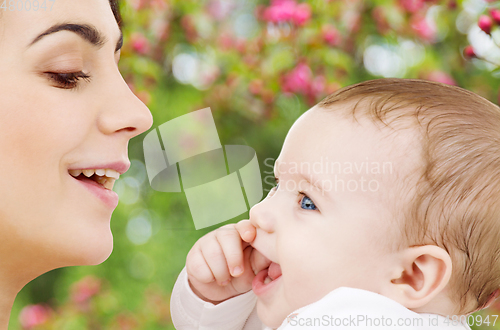 Image of mother with baby over spring garden background