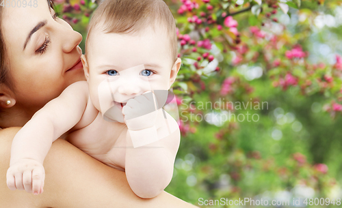 Image of mother with baby over spring garden background