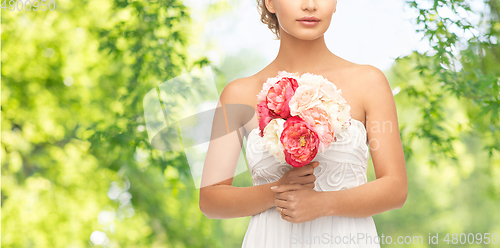 Image of young woman or bride with bouquet of flowers