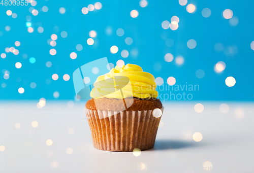 Image of close up of cupcake or muffin with yellow frosting