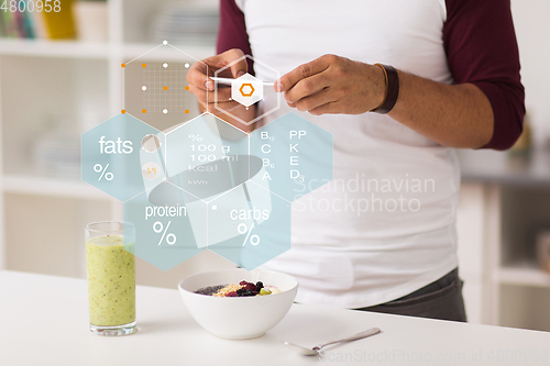 Image of hands with phone and food nutritional value chart