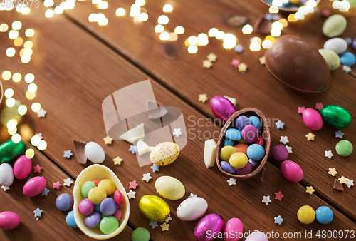 Image of chocolate eggs and candy drops on wooden table
