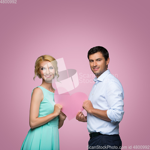 Image of Beautiful couple holding pink heart