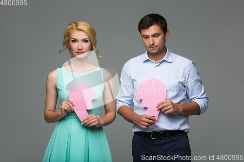 Image of Beautiful couple holding pink broken heart